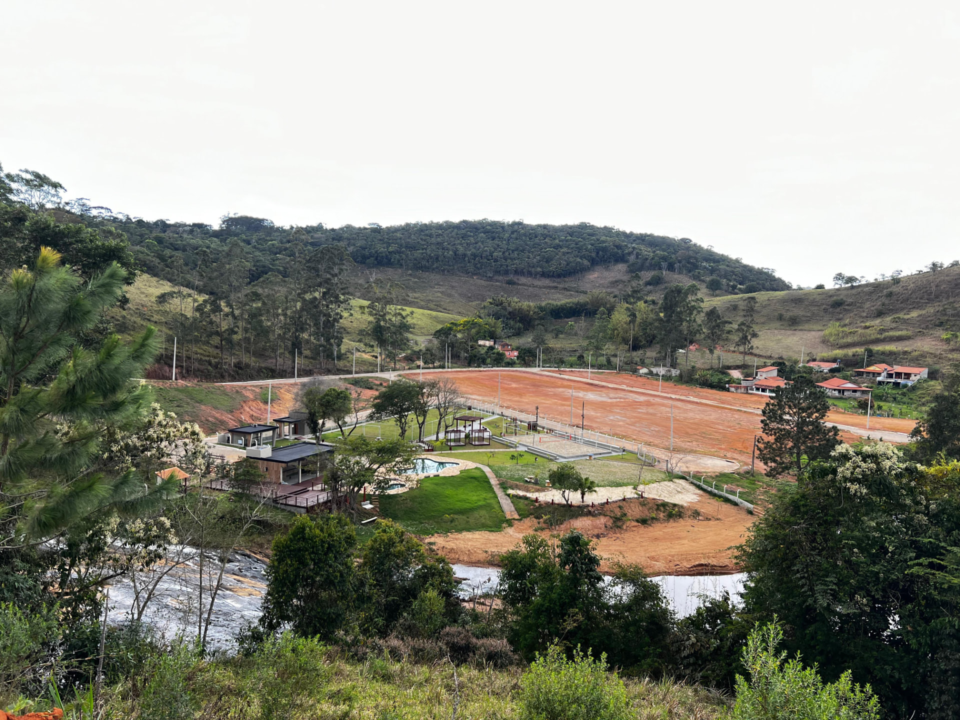 Vista aérea do Recanto das Cachoeiras com ruas abertas, clube e lotes demarcados